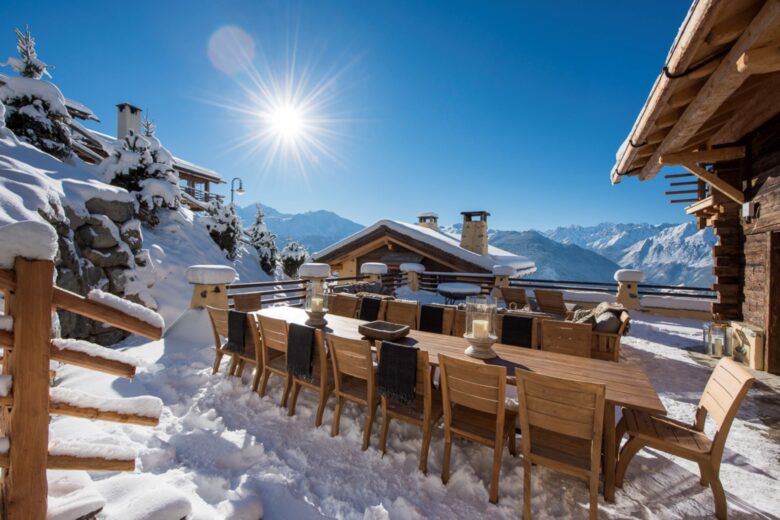 Snowy terrace with dining table at Chalet Chouqui. Part of the luxury chalet club collection