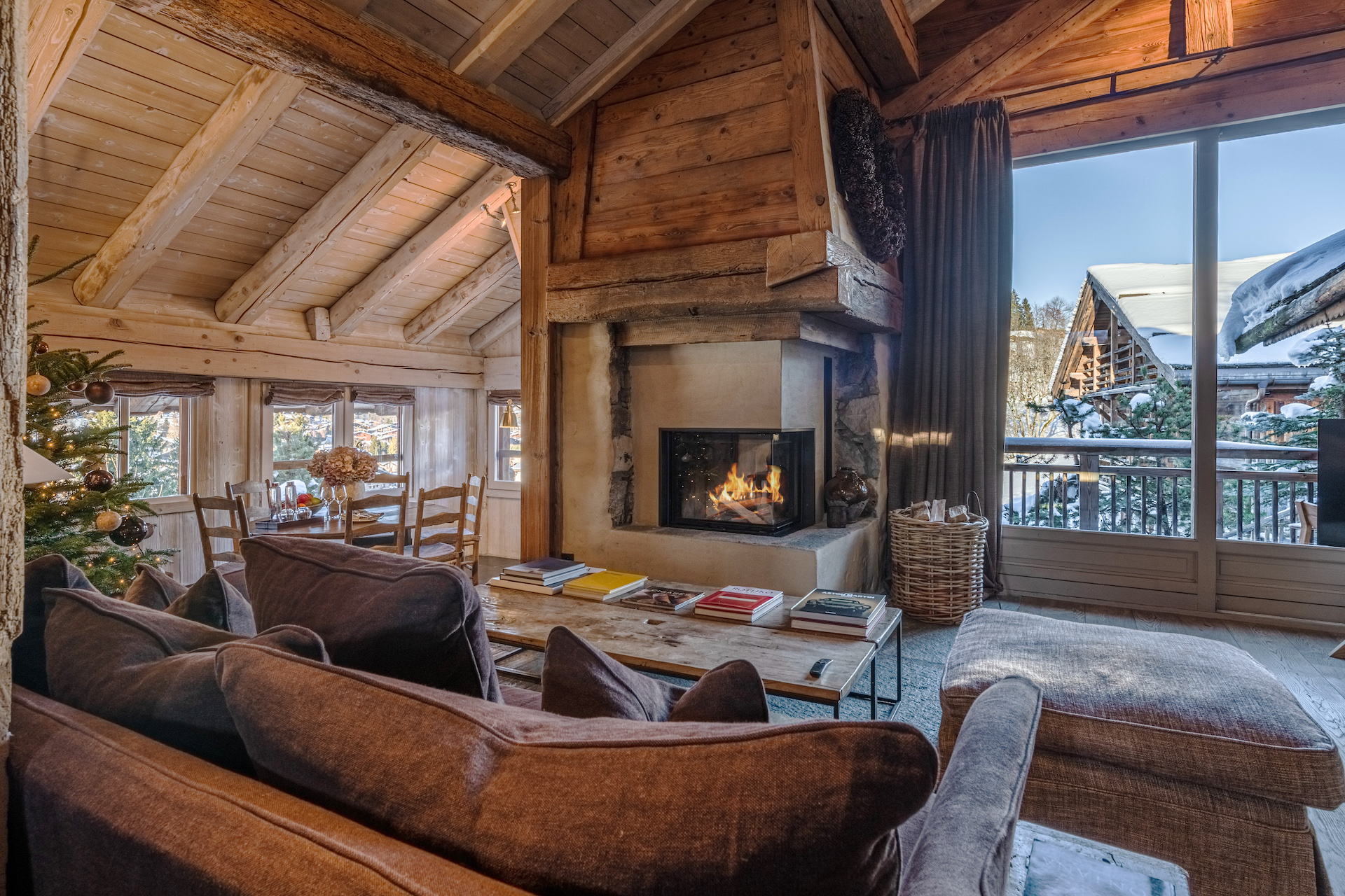 Suite with sofa facing fireplace at Zannier Le Chalet in Megève